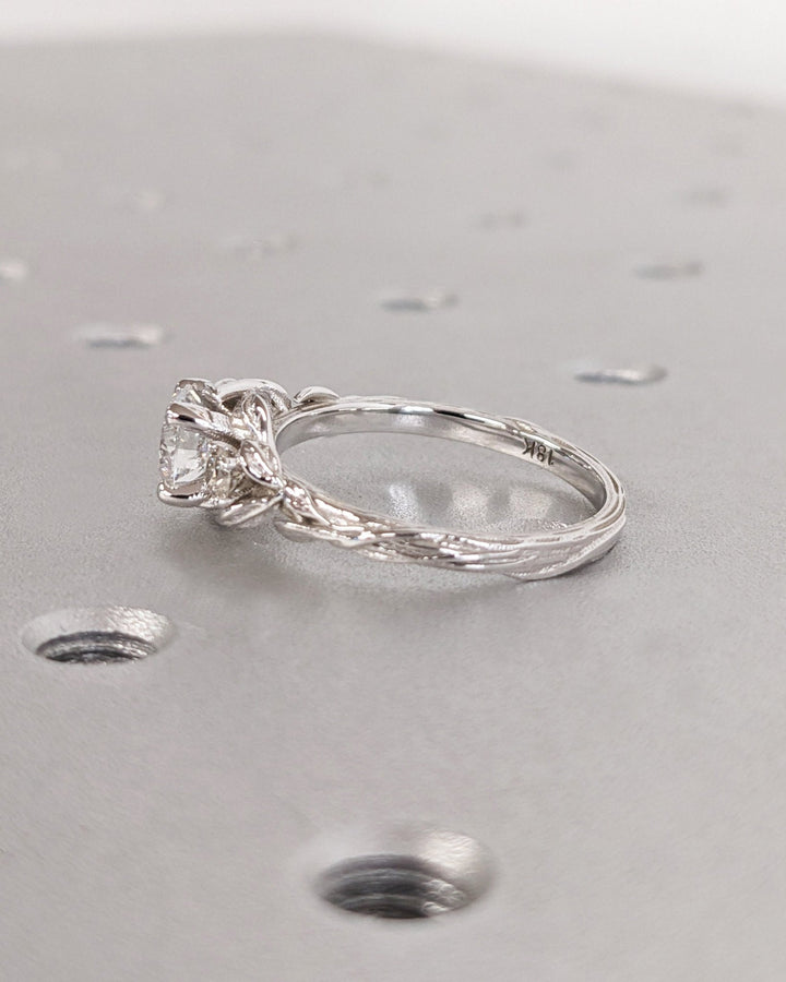 Round cut engagement ring shown with authenticity certificate