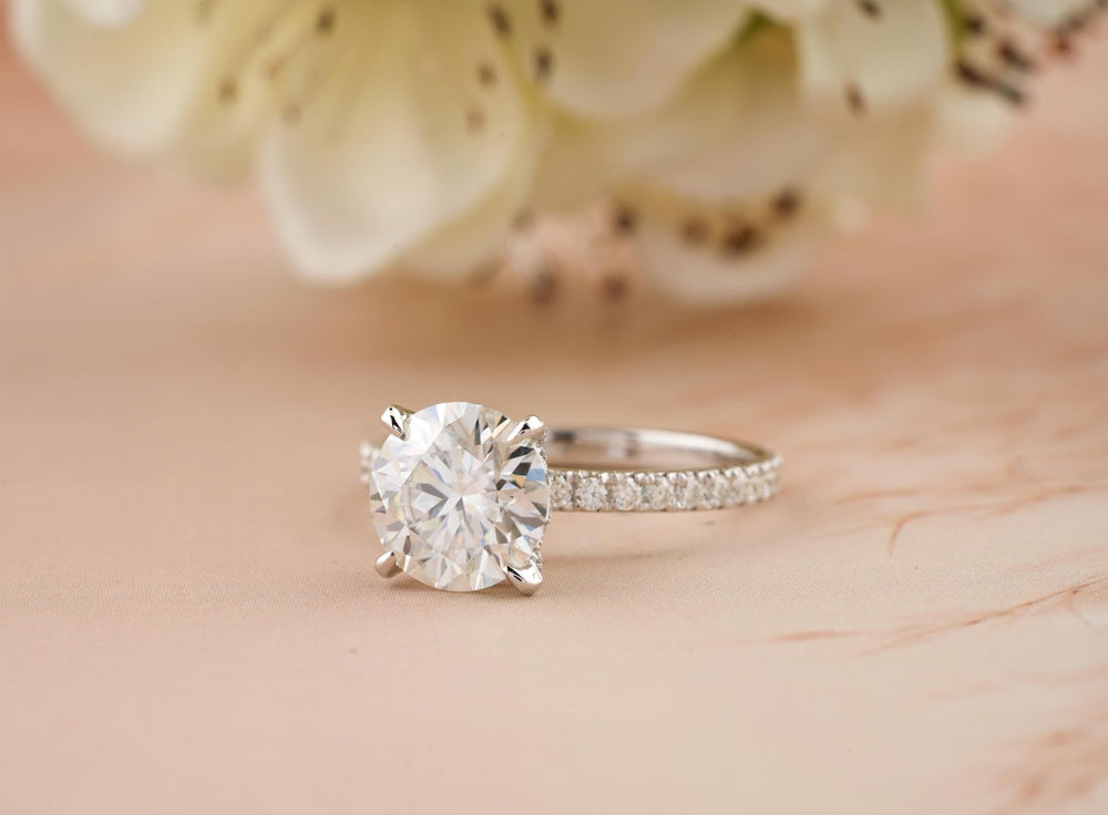 Round cut hidden halo engagement ring shown in real-life wear