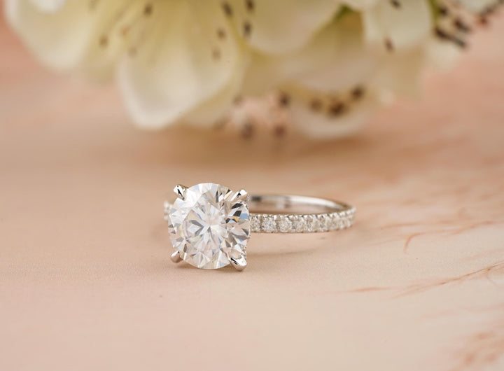 Round cut hidden halo engagement ring shown in real-life wear