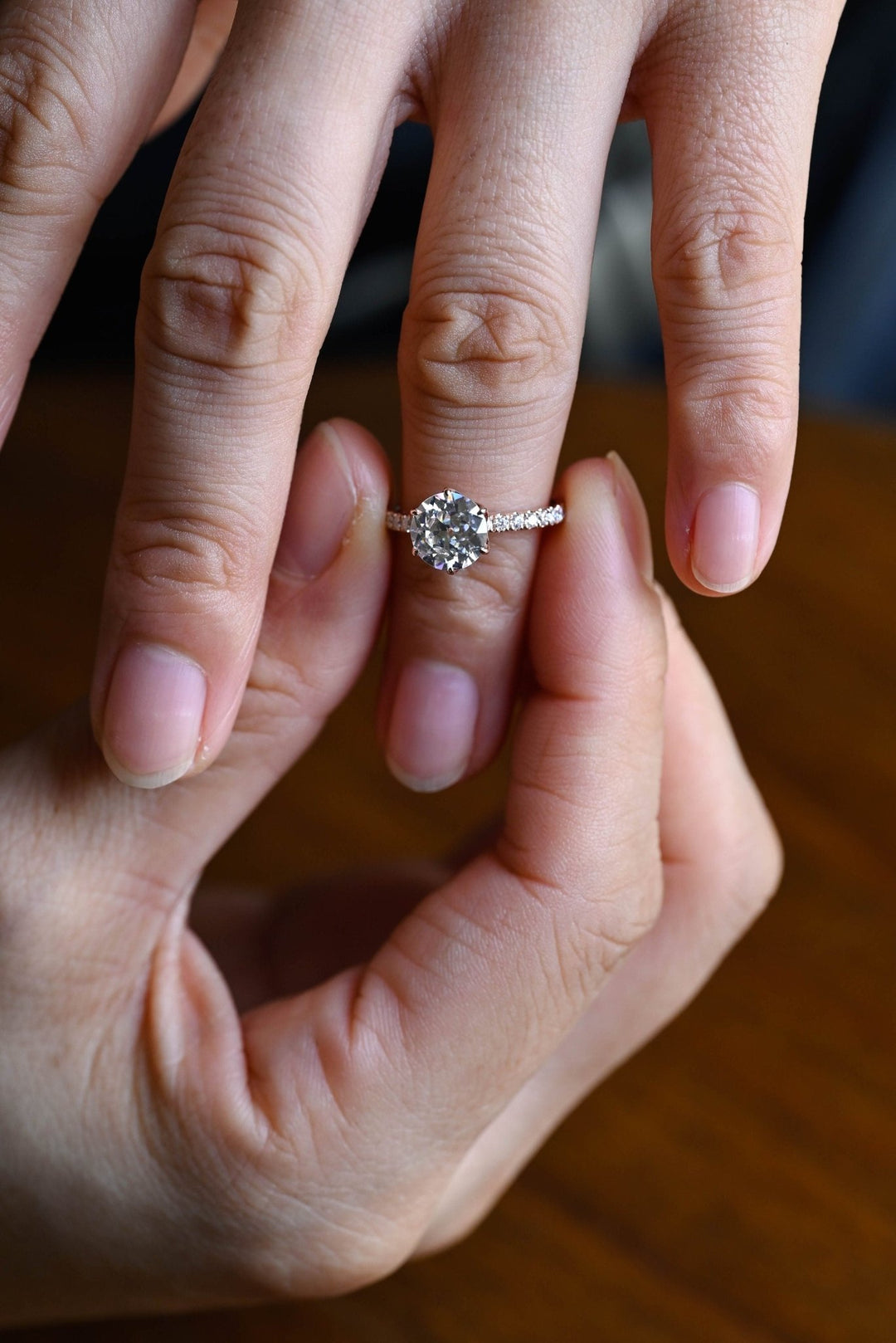 Detailed close-up of round pave diamond engagement ring