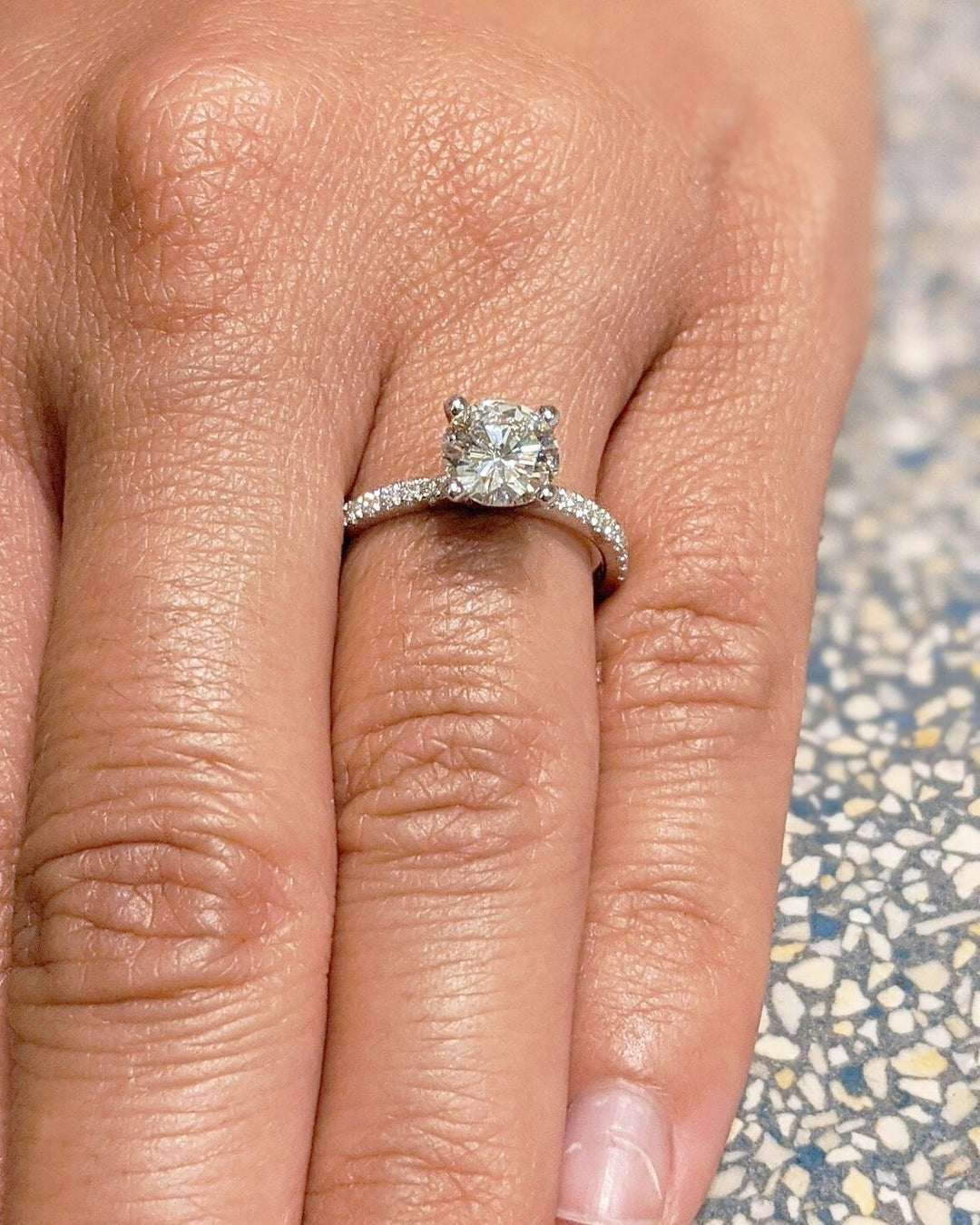 Top-down view of round cut pave engagement ring