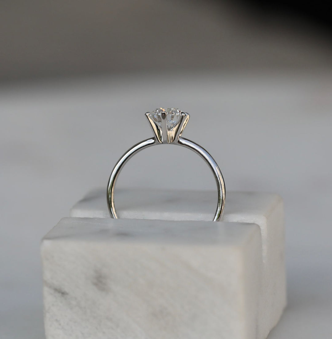 Round solitaire engagement ring with IGI certificate and packaging