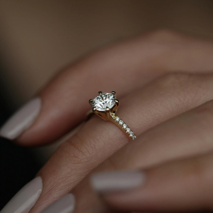 Round solitaire engagement ring viewed from the side