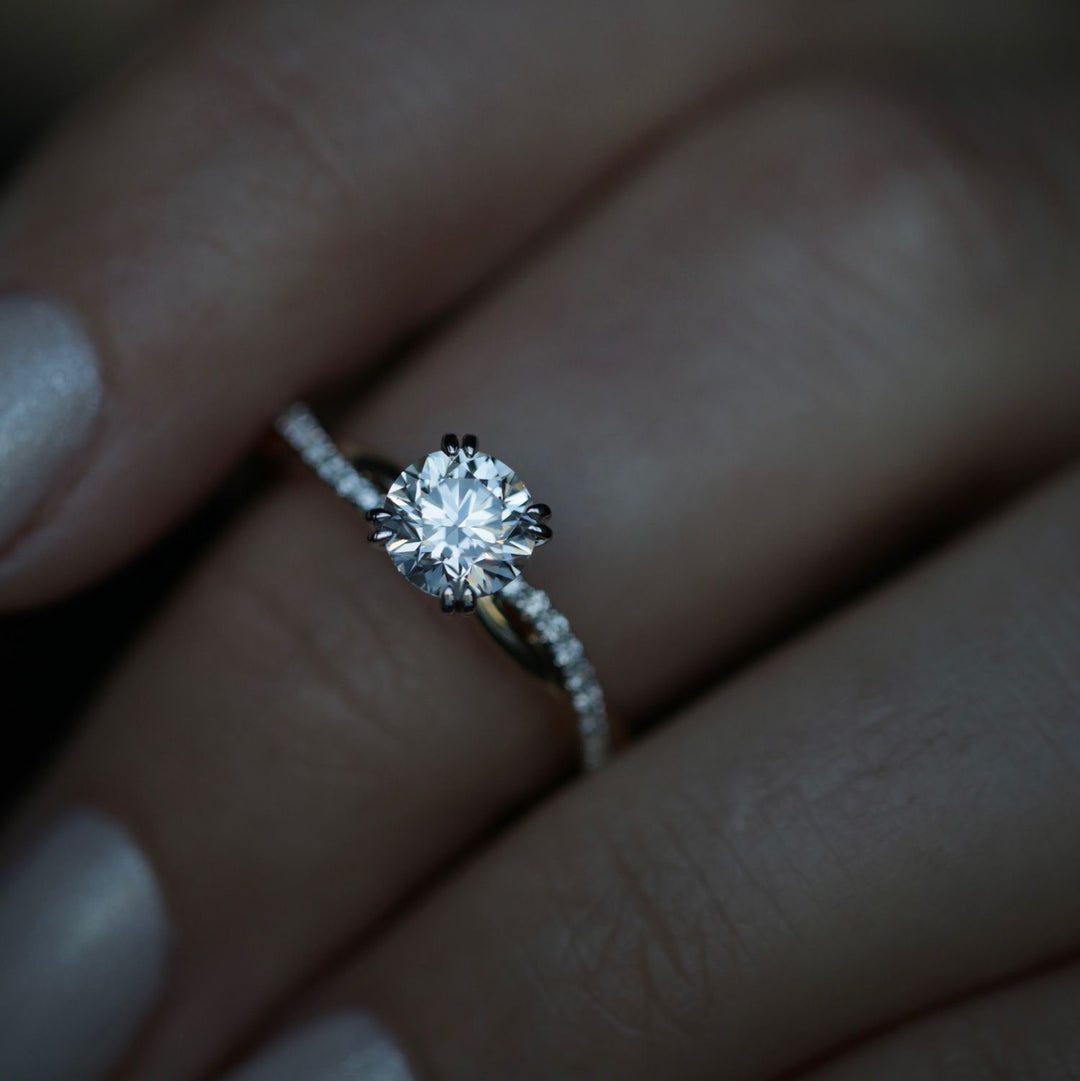 Round solitaire engagement ring viewed from the side