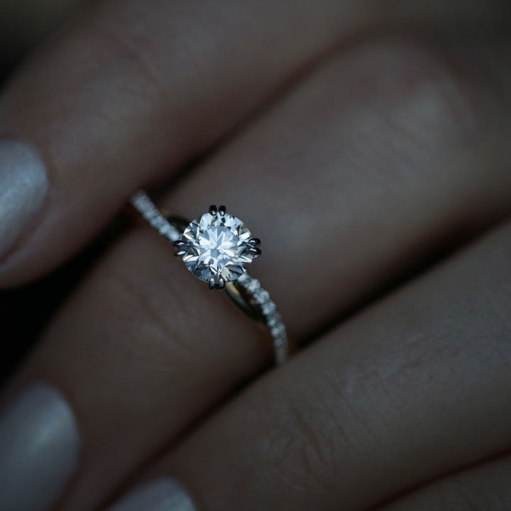Round solitaire engagement ring viewed from the side