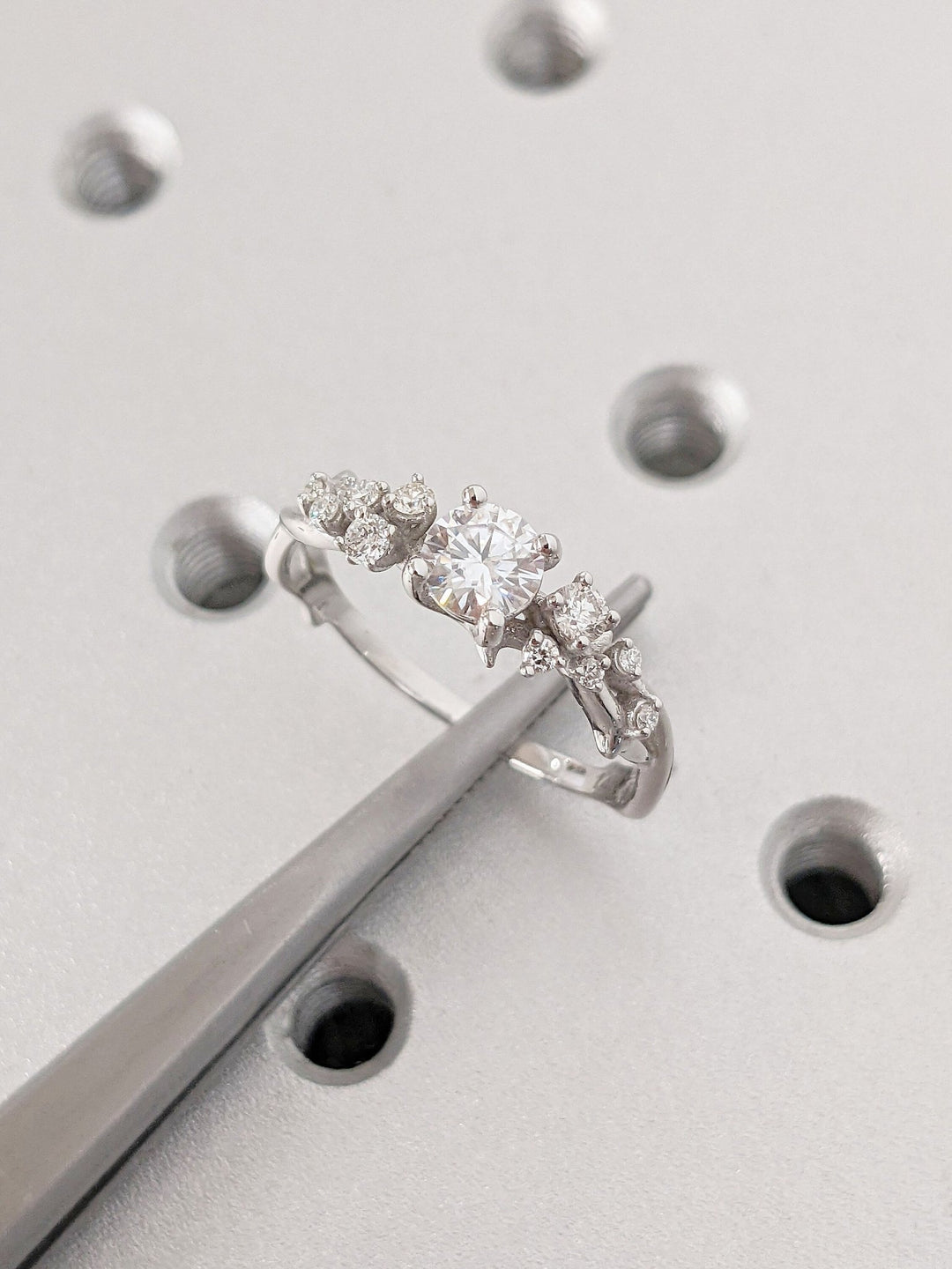 Top-down view of round cut cluster engagement ring
