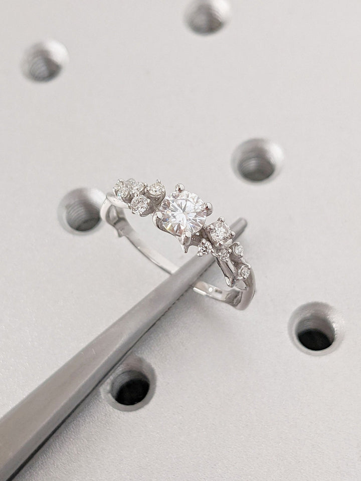 Top-down view of round cut cluster engagement ring