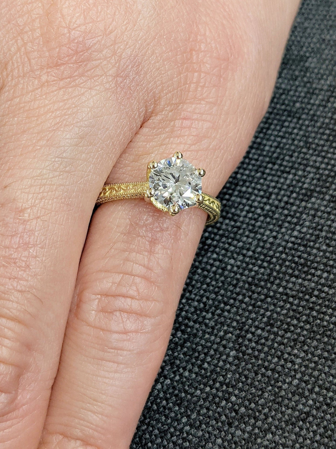 Detailed close-up of round vintage diamond engagement ring