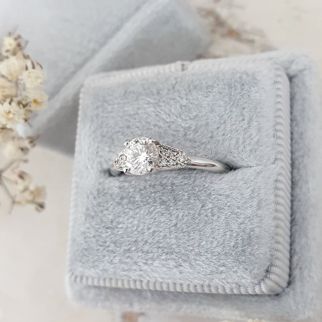 Round milgrain engagement ring with IGI certificate and packaging