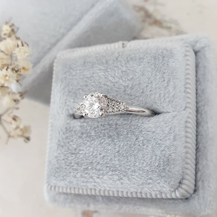 Round milgrain engagement ring with IGI certificate and packaging