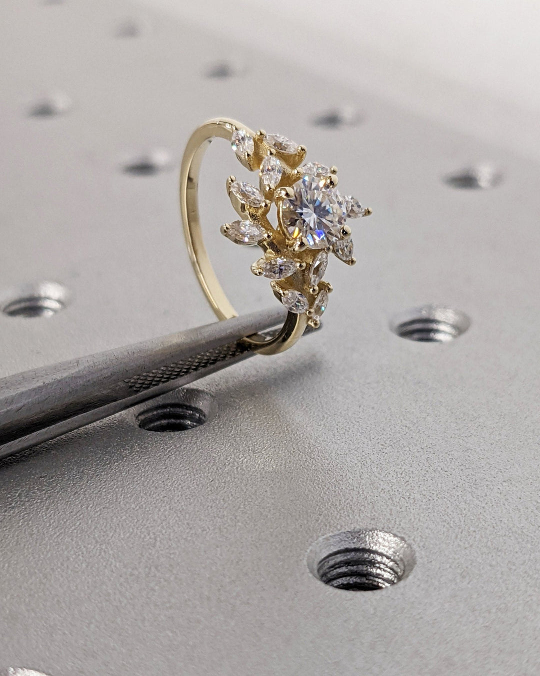 Certified round cut diamond featured in cluster engagement ring