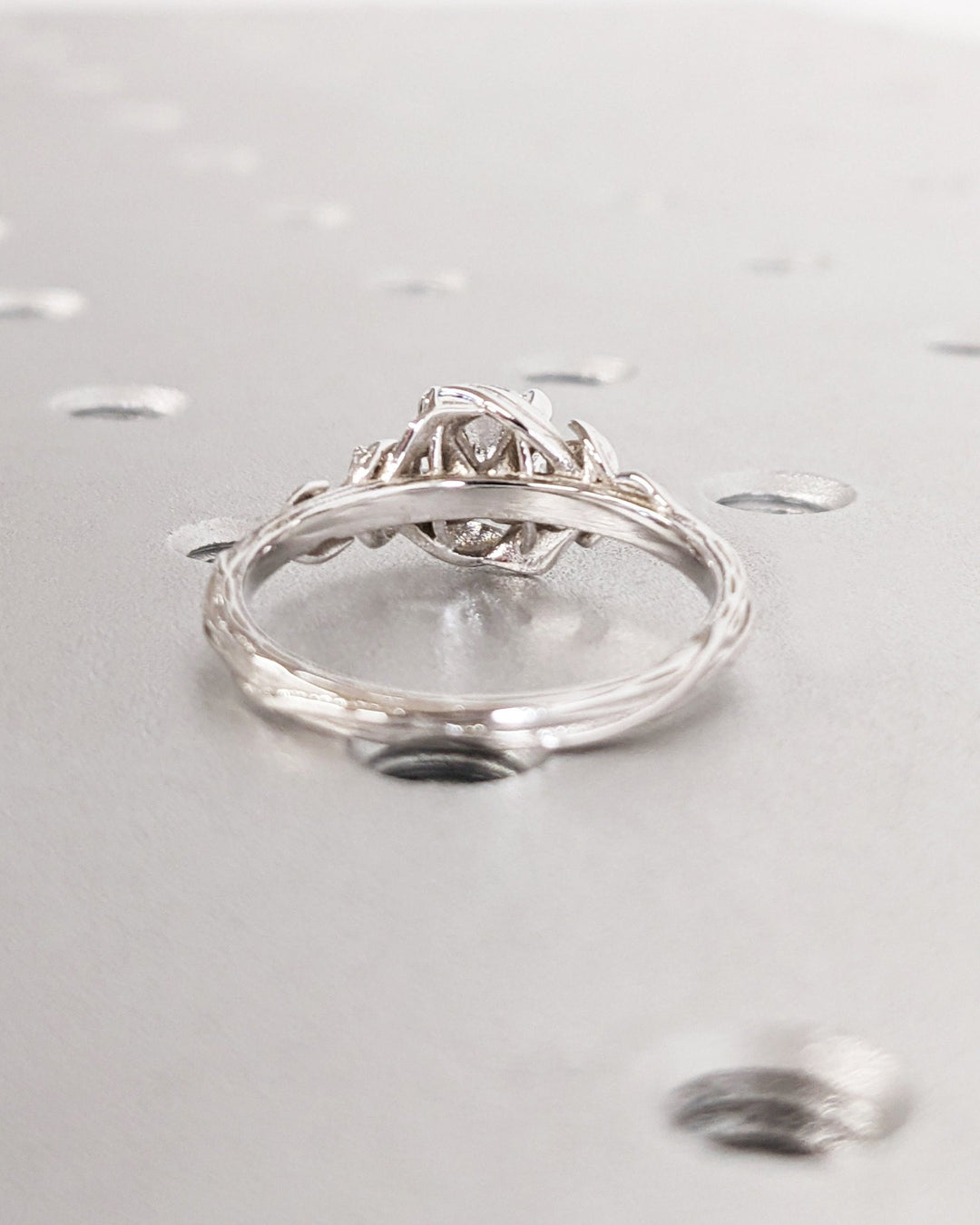 Round three stone diamond ring presented in signature gift packaging