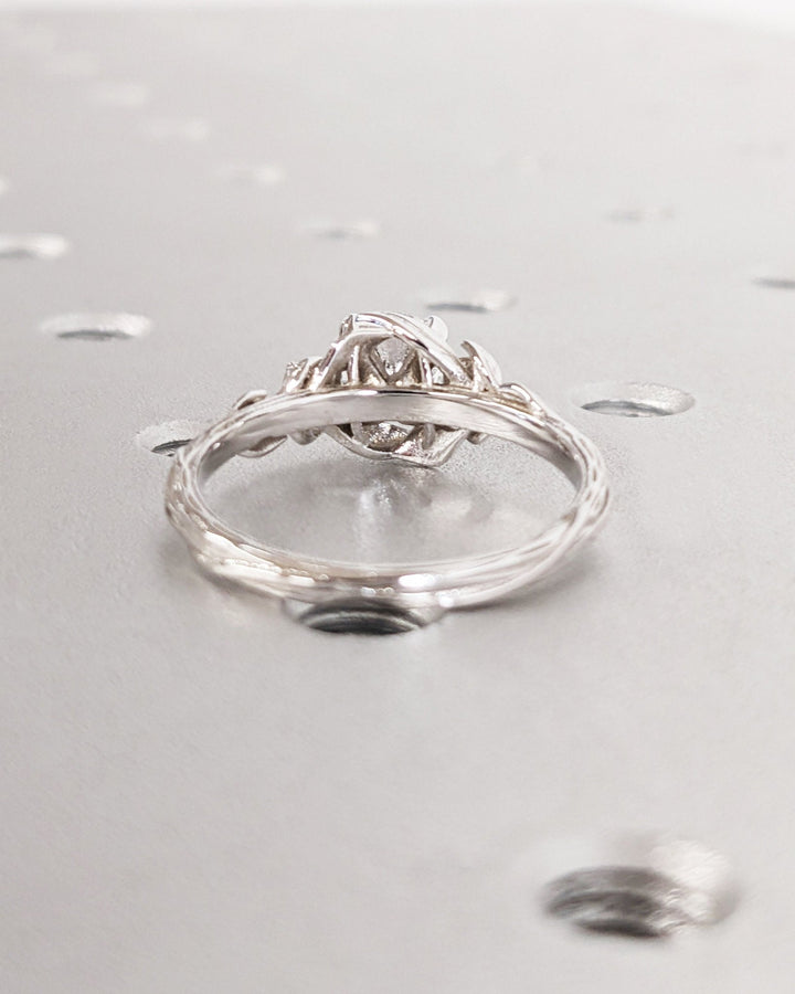 Round three stone diamond ring presented in signature gift packaging