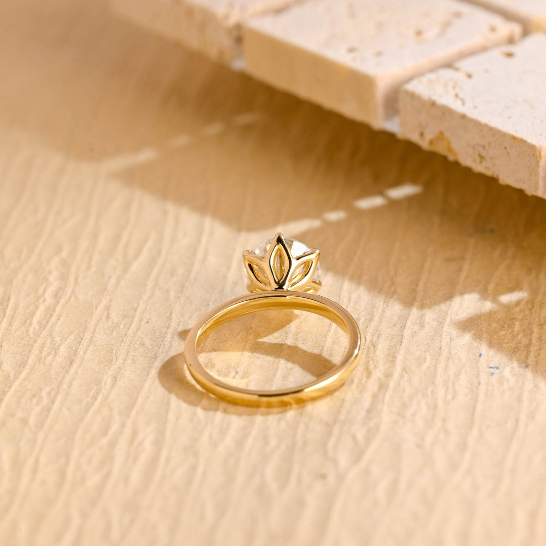 Round solitaire engagement ring viewed from the side