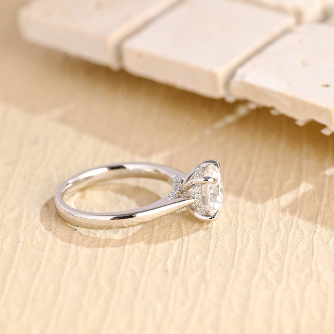 Round hidden halo engagement ring offered in gold and platinum