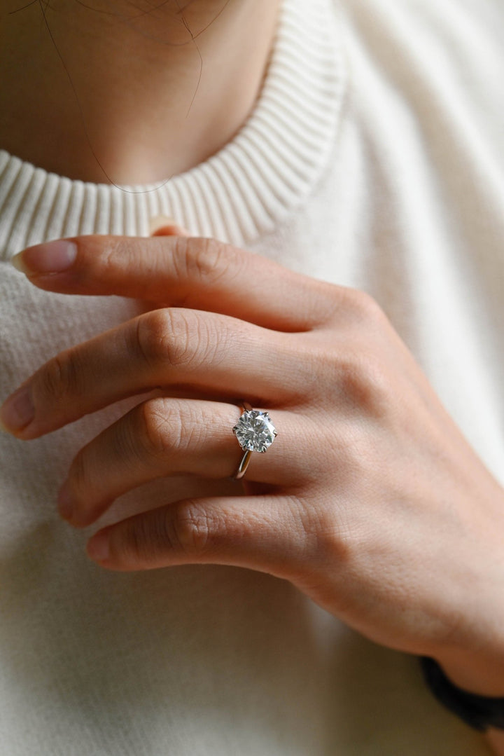 Round cut solitaire engagement ring shown in real-life wear