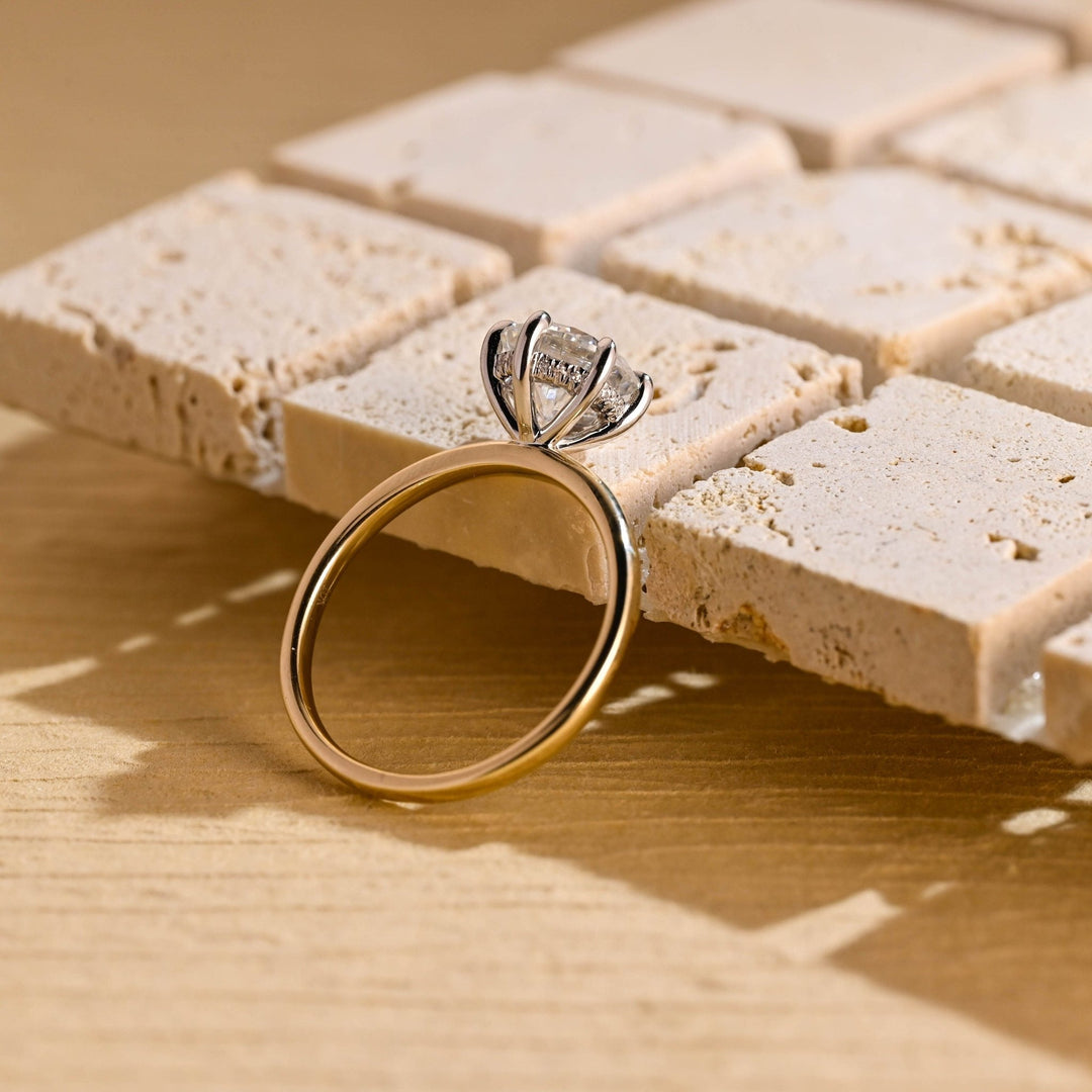 Round hidden halo engagement ring finished in polished solid gold