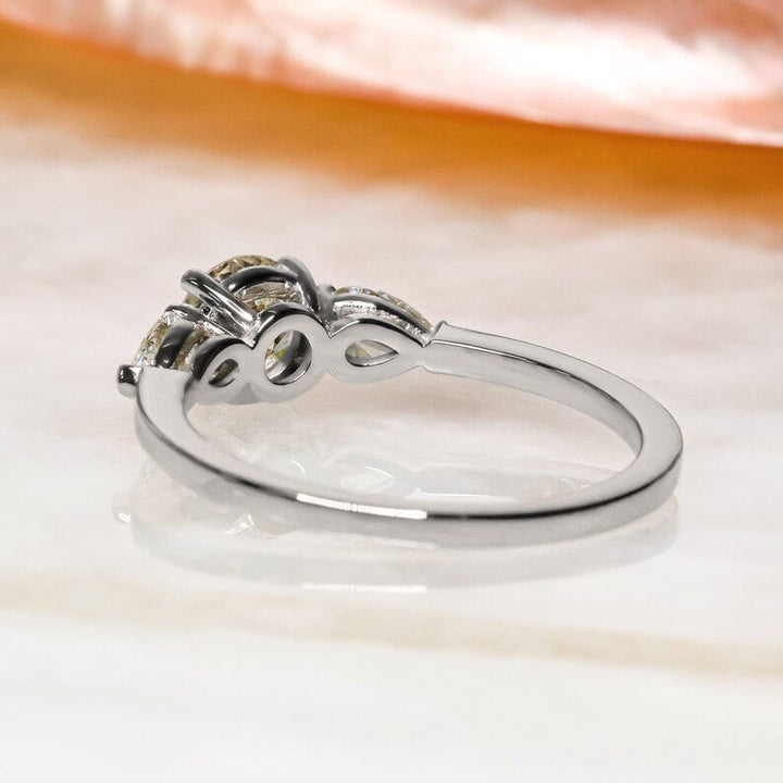 Round three stone ring set with an IGI graded diamond
