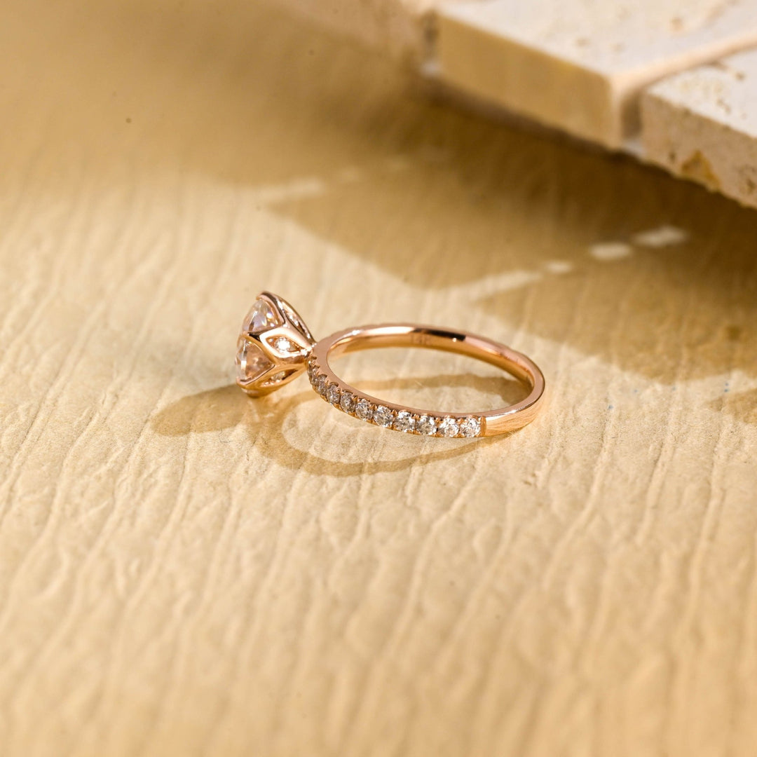 Close-up of round cut center diamond in pave engagement ring