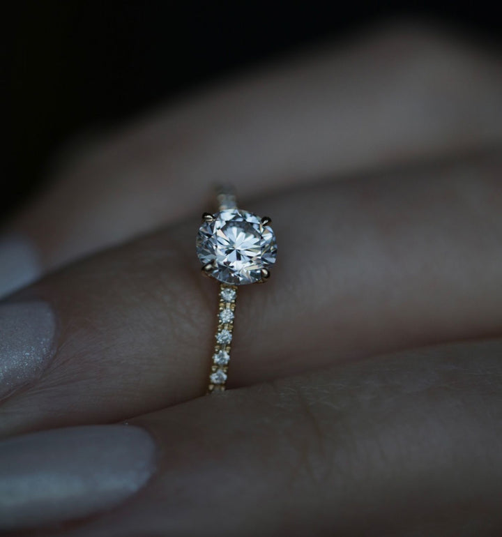 Detailed close-up of round solitaire diamond engagement ring