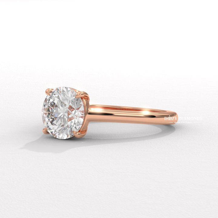 Round solitaire engagement ring shown on hand for true-to-life sizing