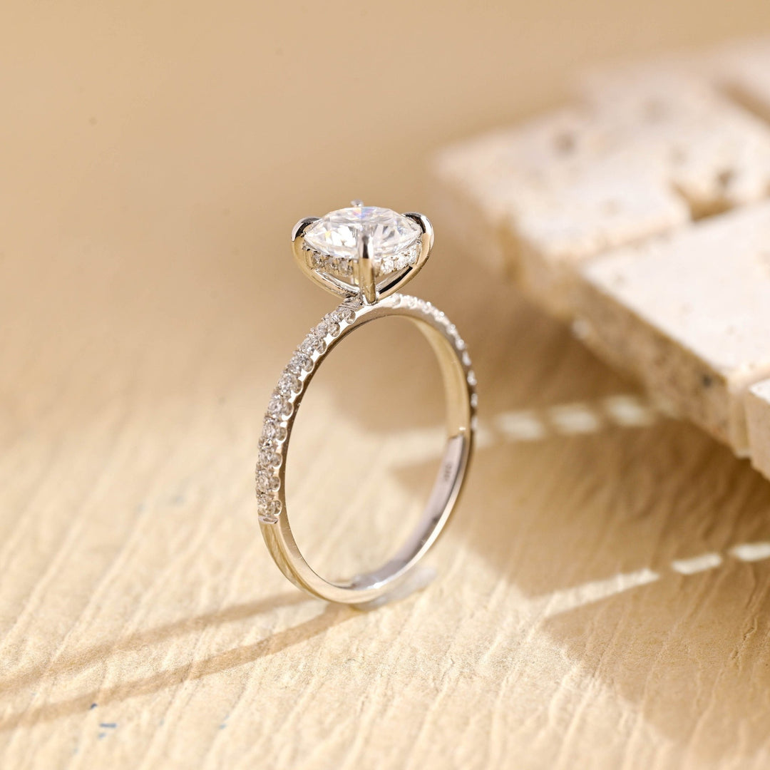 Detailed close-up of round hidden halo diamond engagement ring
