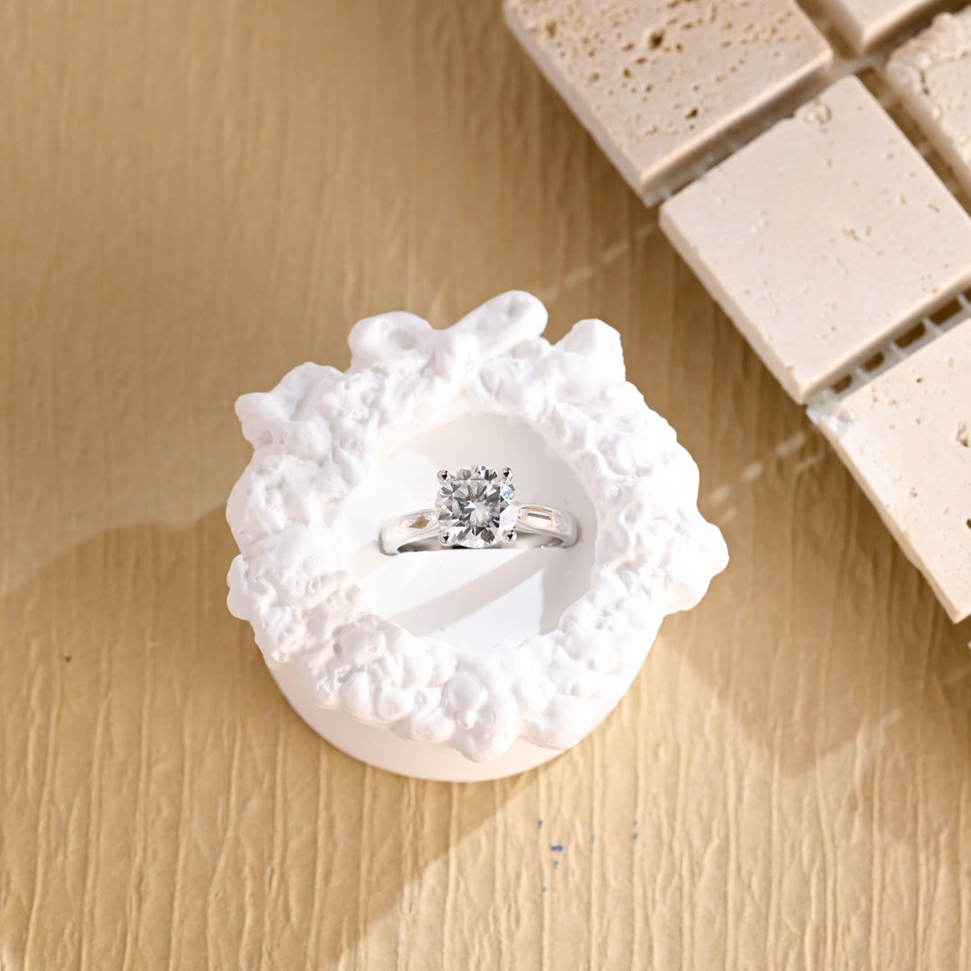 Round solitaire engagement ring photographed in natural light
