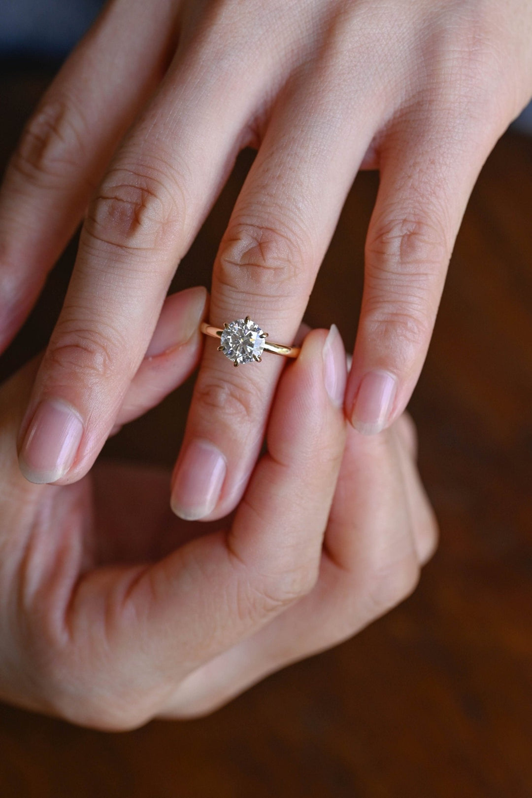 Round solitaire engagement ring finished in polished solid gold