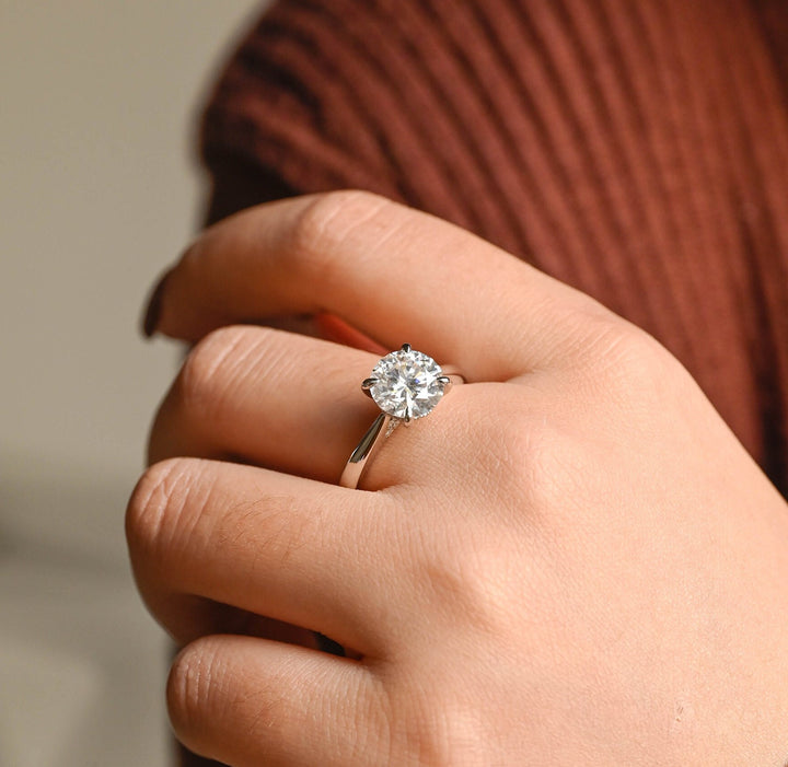 Unboxing view of round cut hidden halo diamond engagement ring