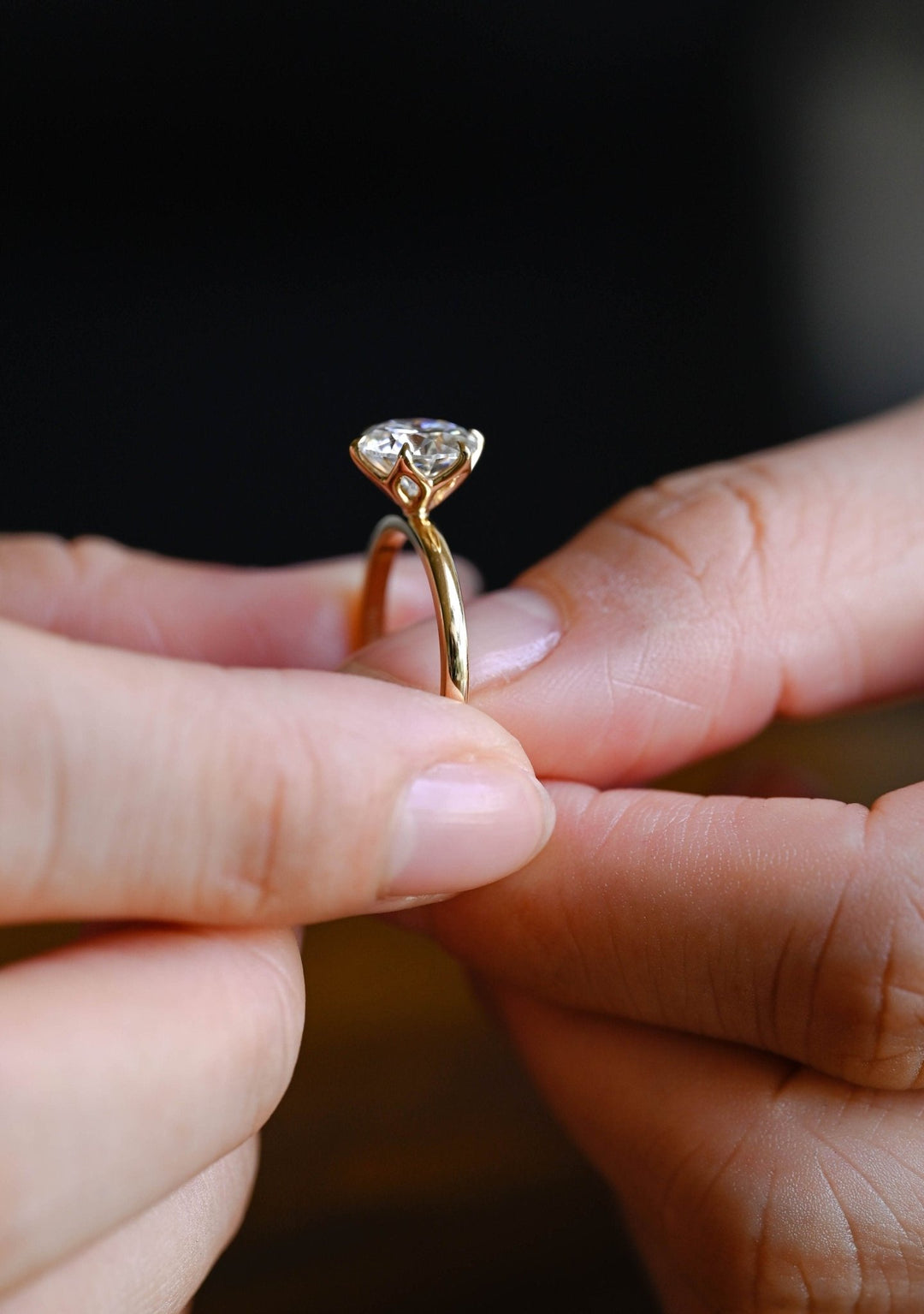 Round solitaire engagement ring shown on hand for true-to-life sizing