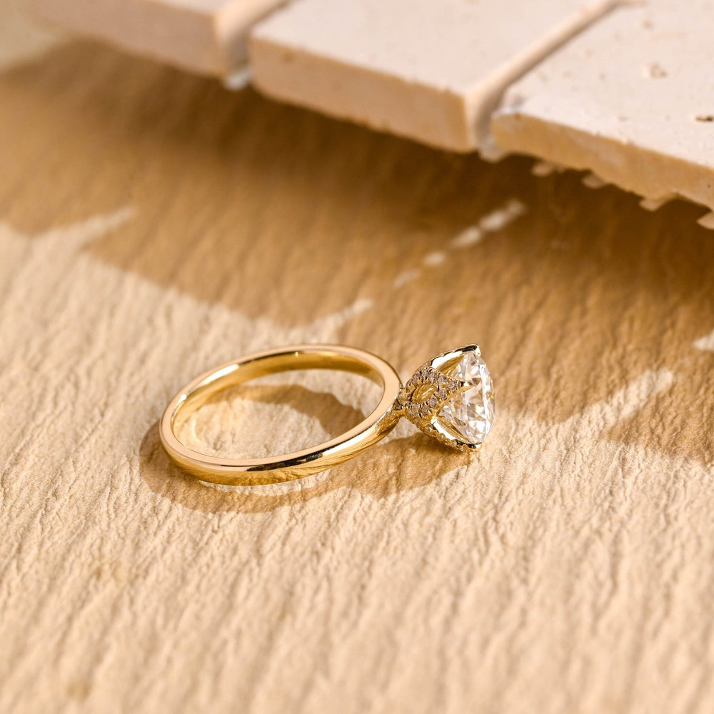 Round hidden halo diamond ring presented in signature gift packaging