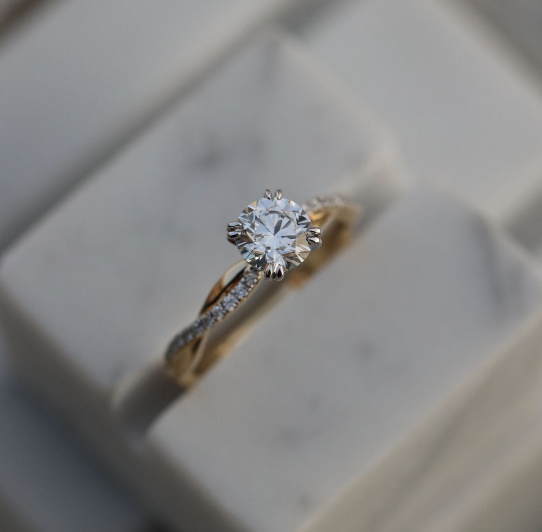 Round solitaire engagement ring close-up showing E/VS1 diamond clarity