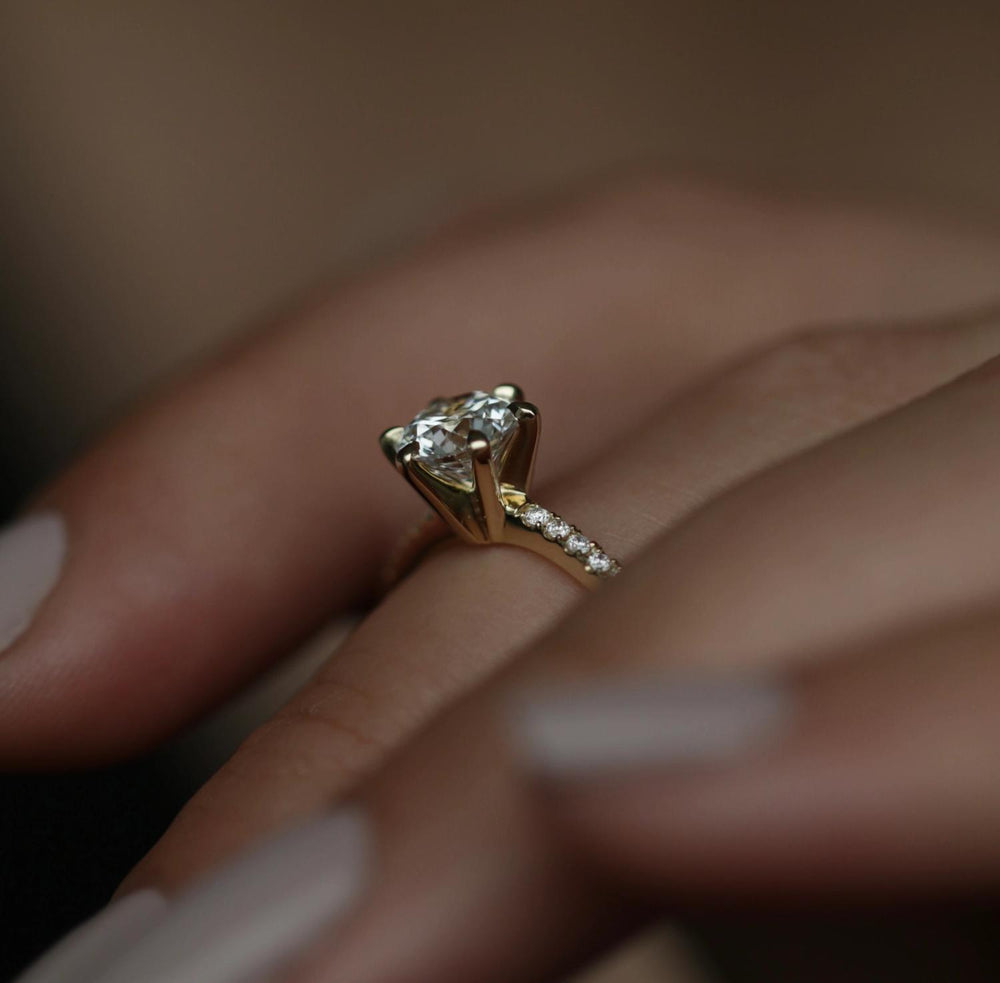 Round solitaire engagement ring close-up highlighting diamond sparkle