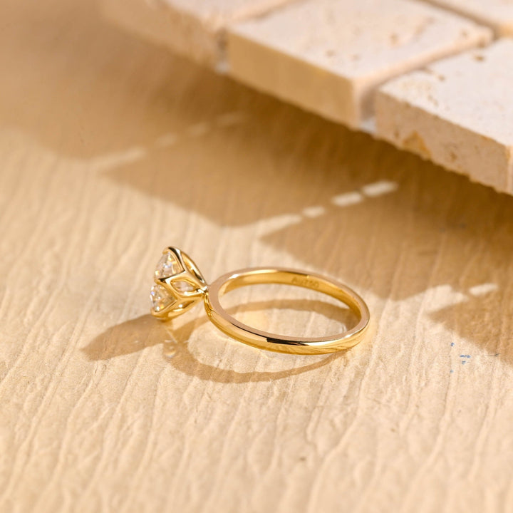 Profile view of round cut solitaire engagement ring band