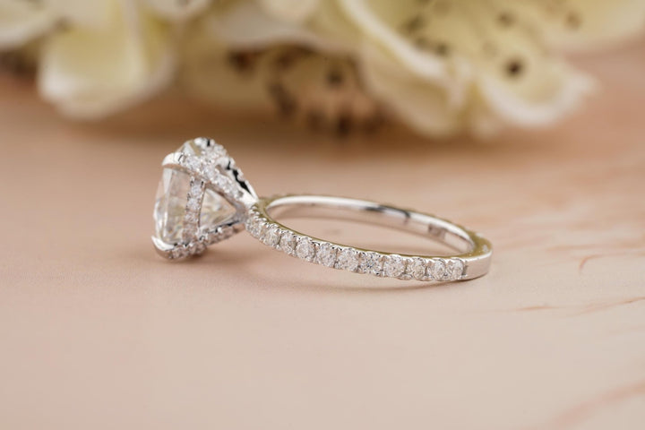 Detailed close-up of round hidden halo diamond engagement ring