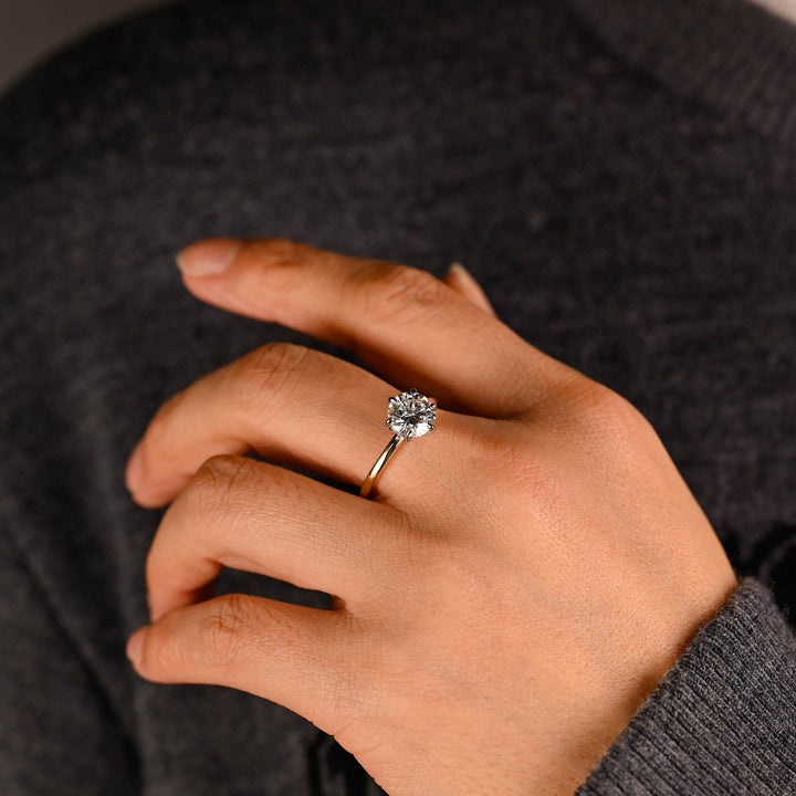 Round hidden halo diamond ring displayed on jewelry stand