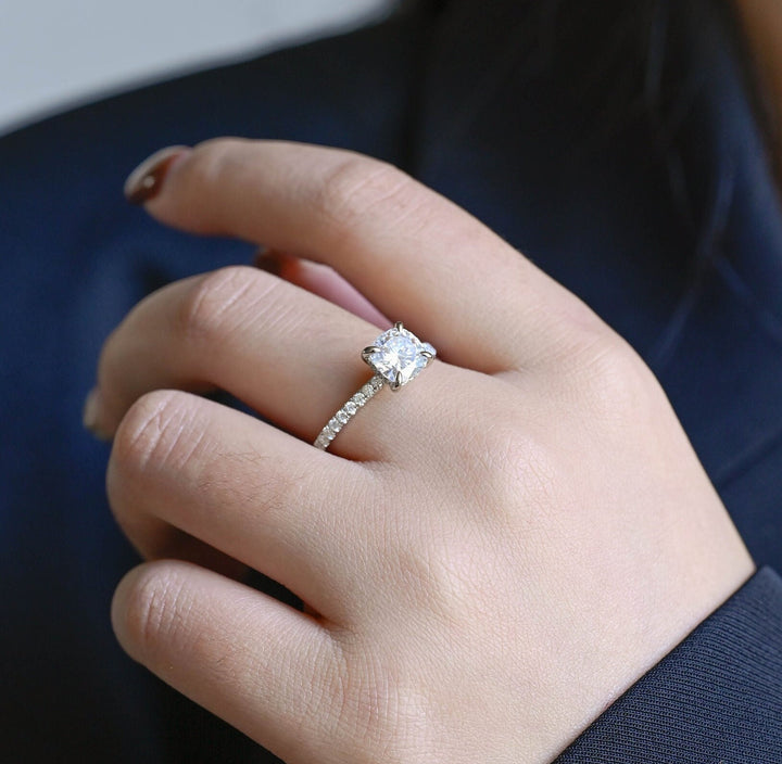 Round hidden halo engagement ring viewed from the side