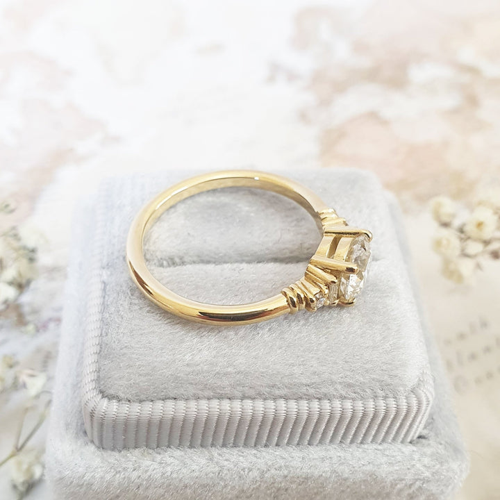 Round cluster diamond ring displayed on jewelry stand