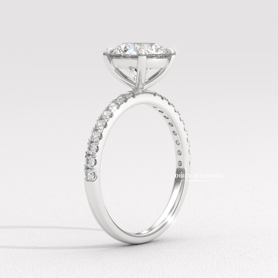 Close-up of round cut center diamond in pave engagement ring