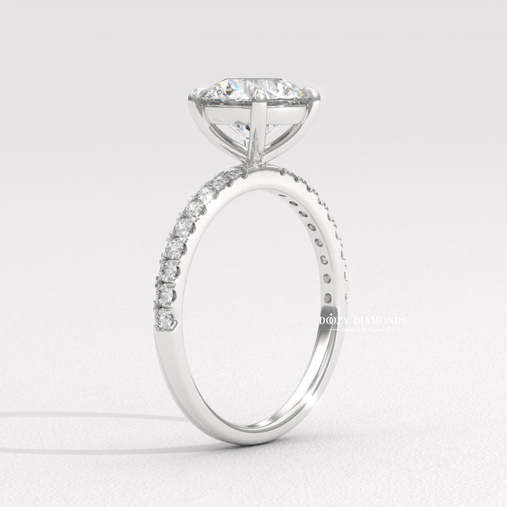 Close-up of round cut center diamond in pave engagement ring