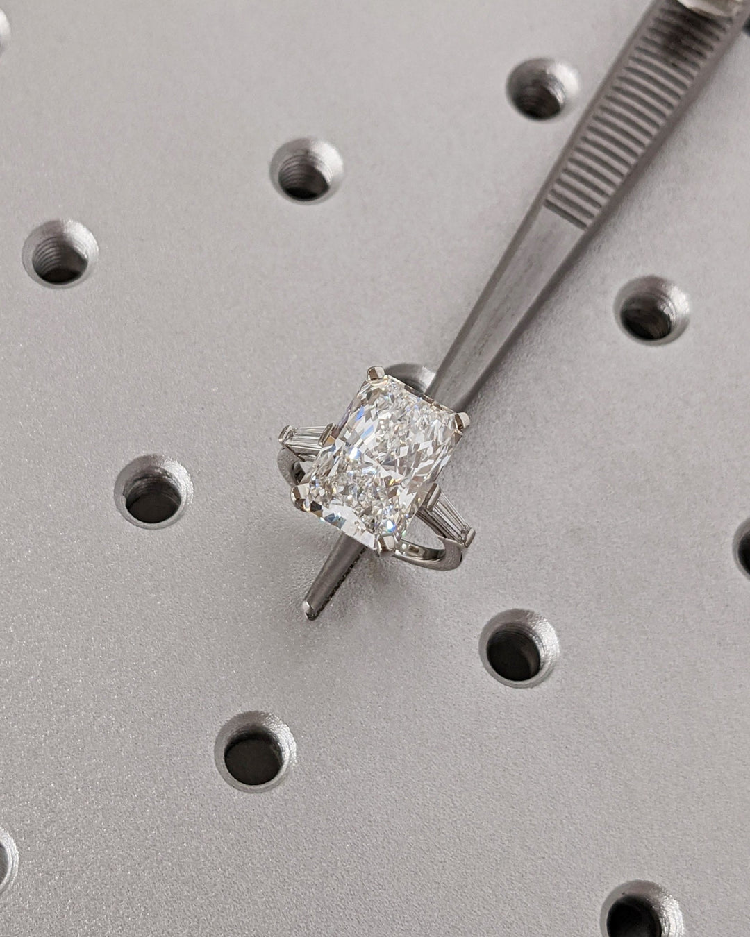 Side angle of radiant three stone diamond engagement ring