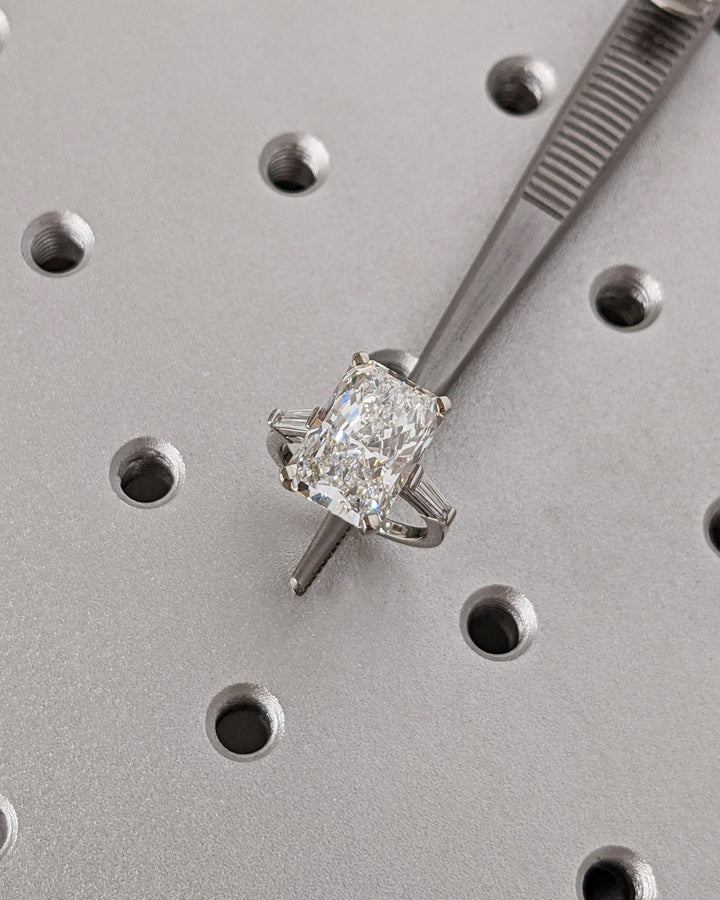Side angle of radiant three stone diamond engagement ring