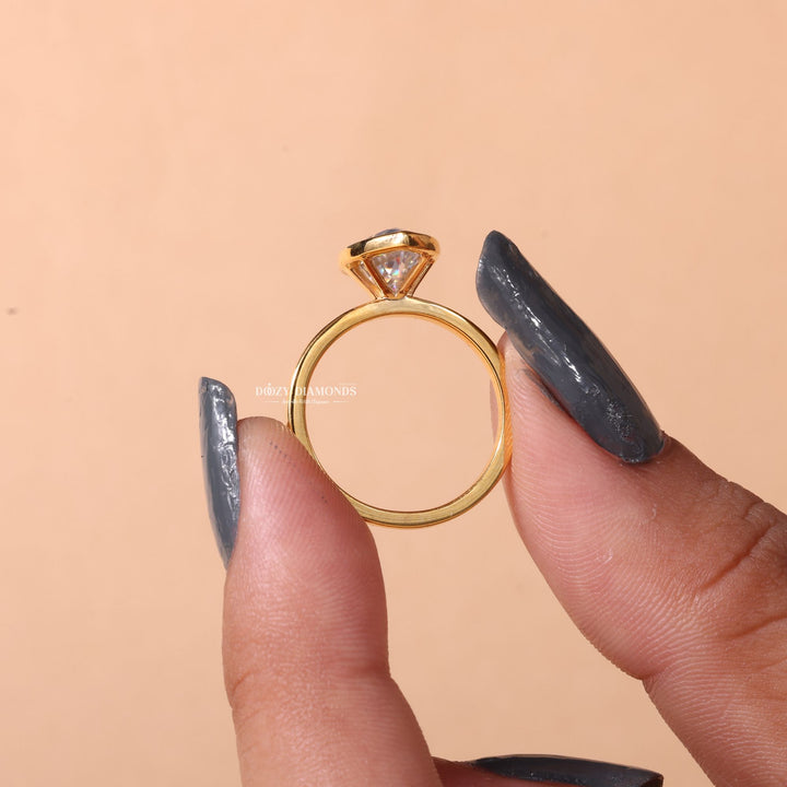 Certified marquise cut diamond featured in bezel engagement ring