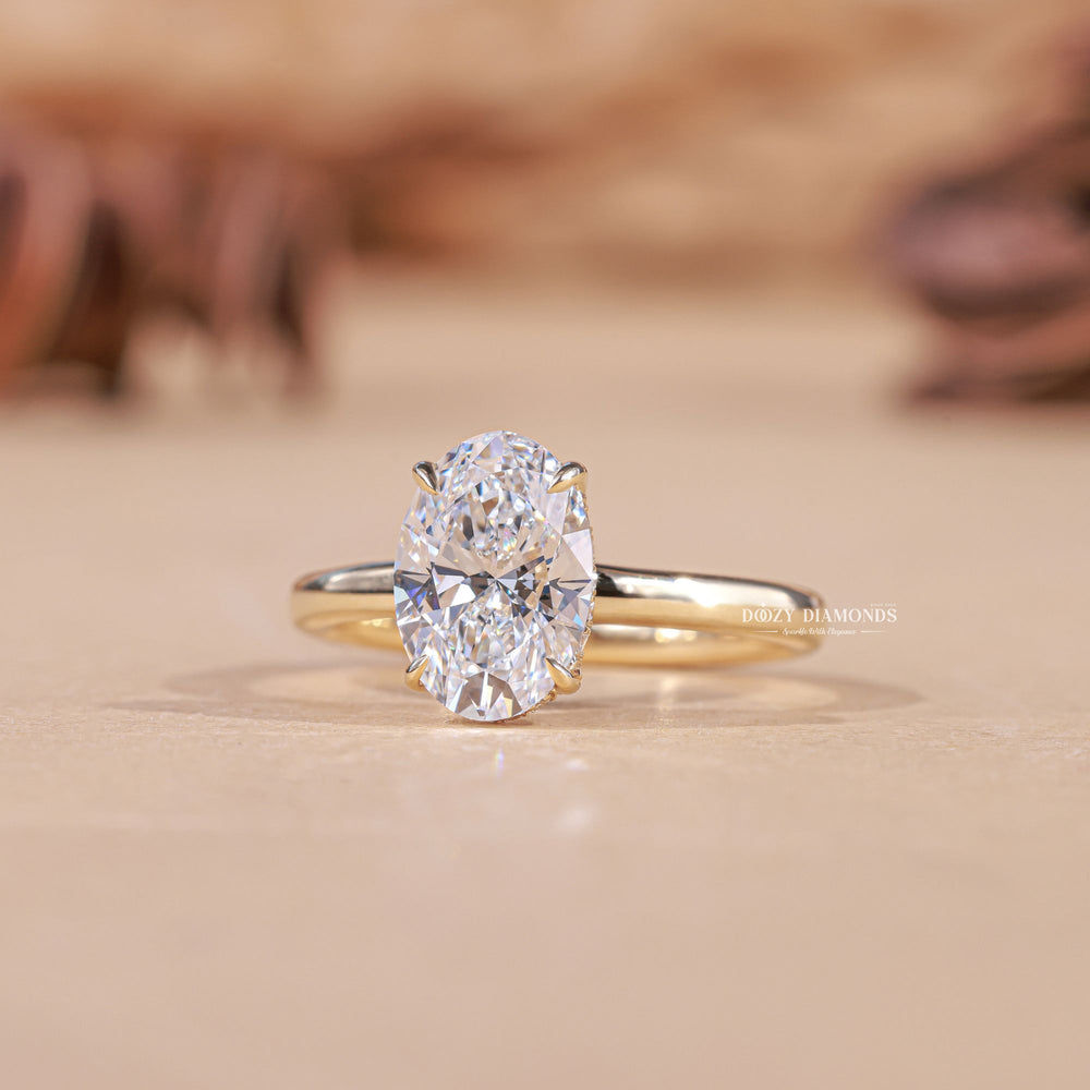Oval hidden halo diamond ring presented in signature gift packaging