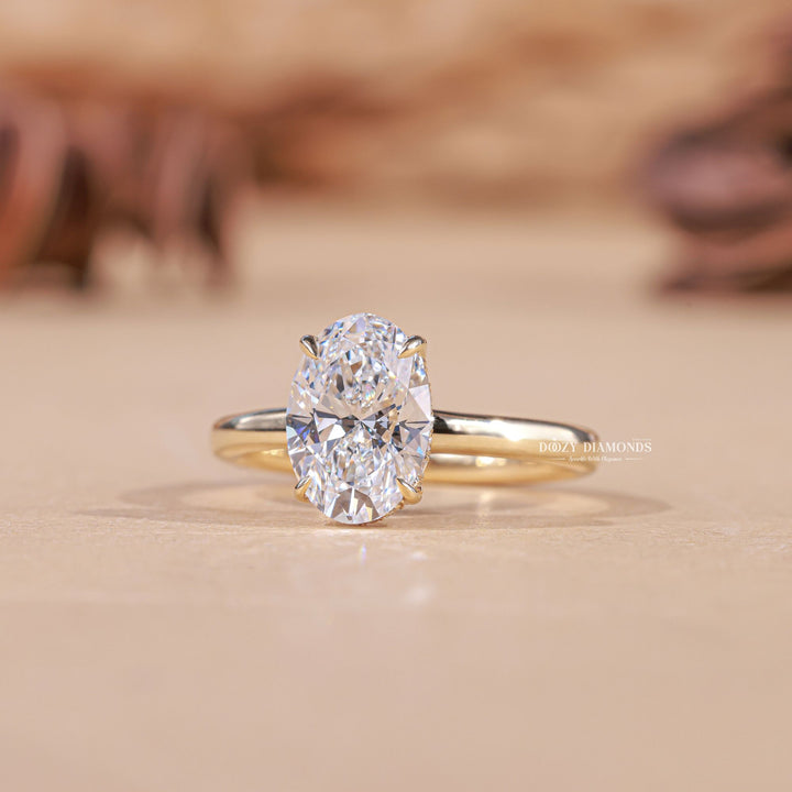 Oval hidden halo diamond ring presented in signature gift packaging