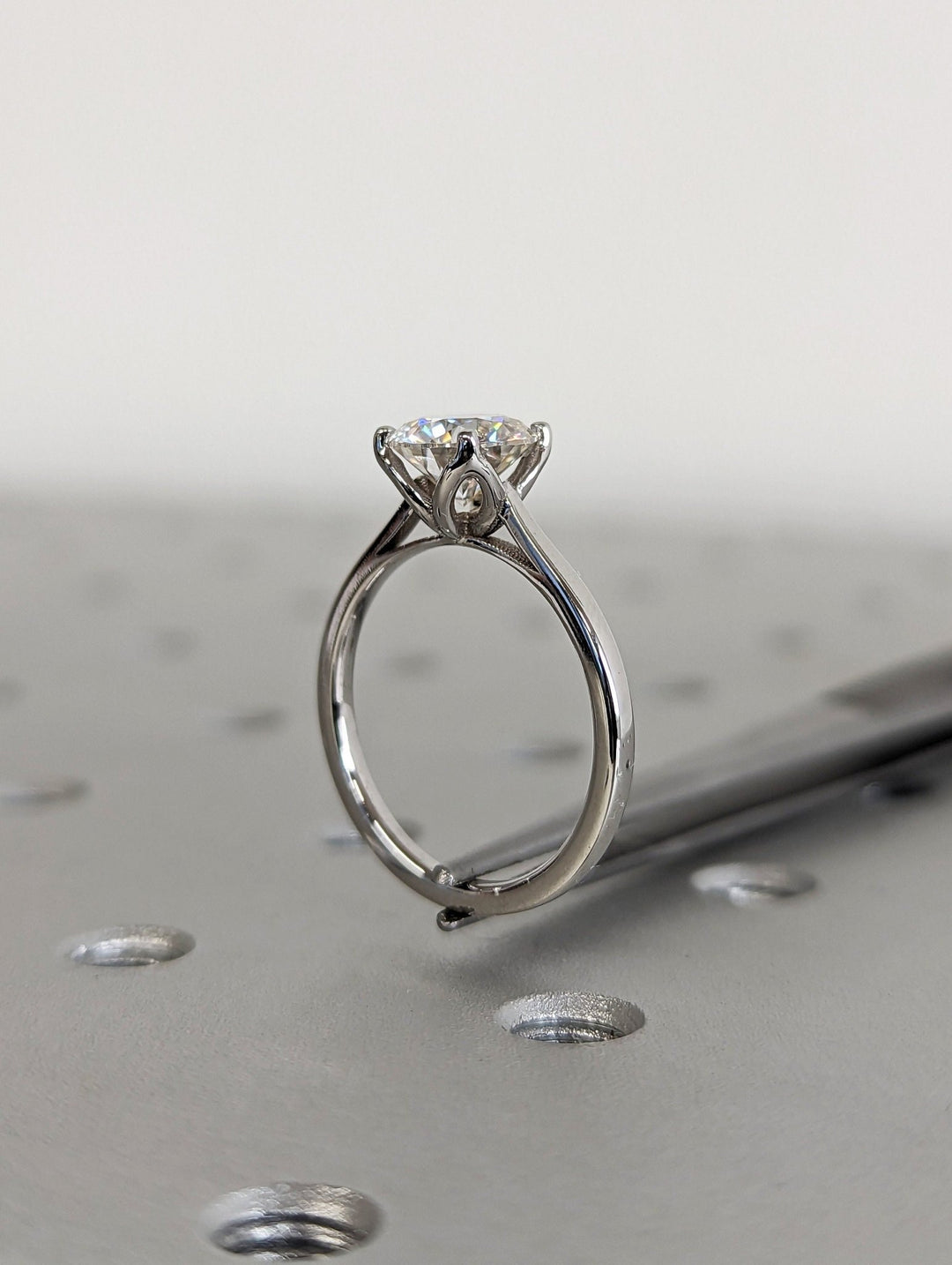 Round solitaire engagement ring viewed from the side