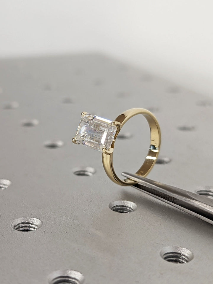 Emerald cut engagement ring side view showing band detail