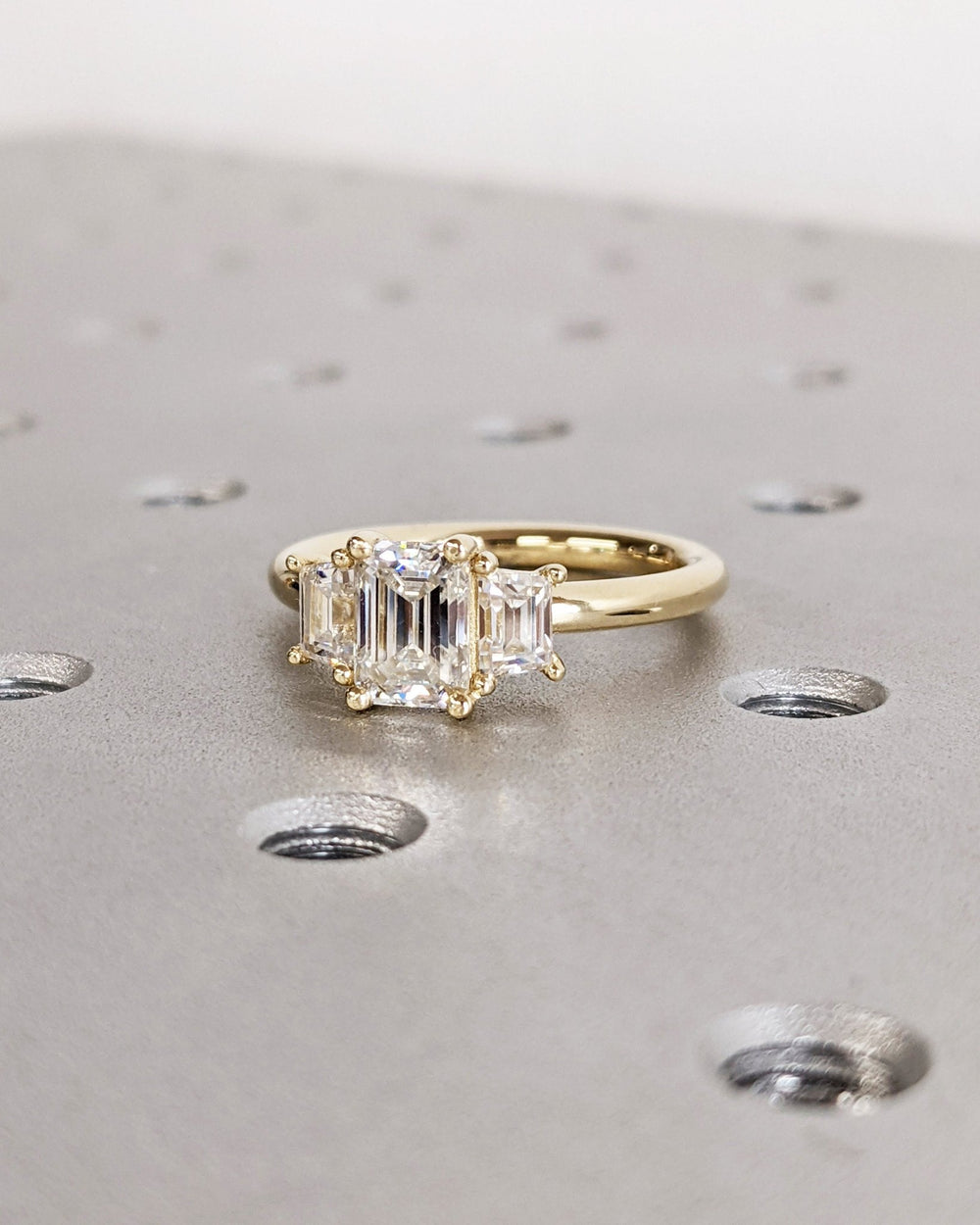 Emerald solitaire engagement ring finished in polished solid gold