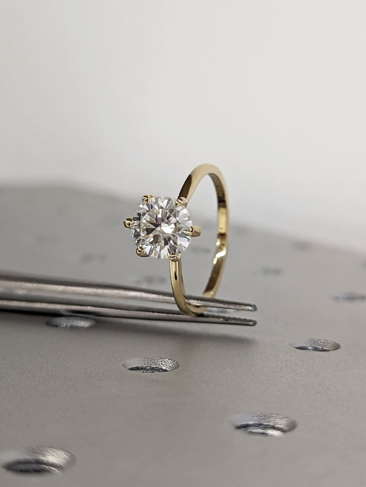 Round solitaire engagement ring with IGI certificate and packaging