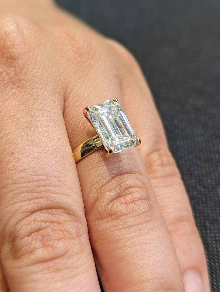 Close-up of emerald cut center diamond in solitaire engagement ring